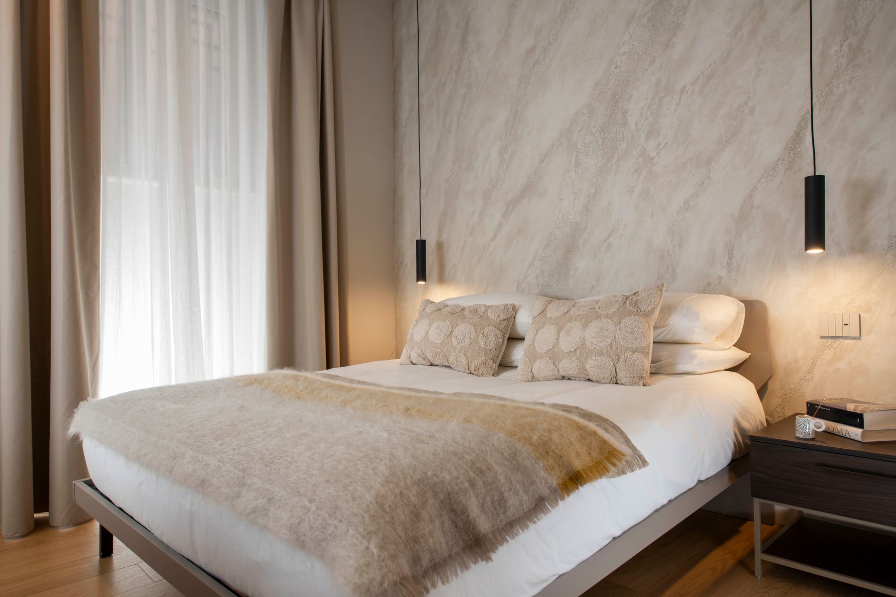 Master bedroom with sculpted plaster wall