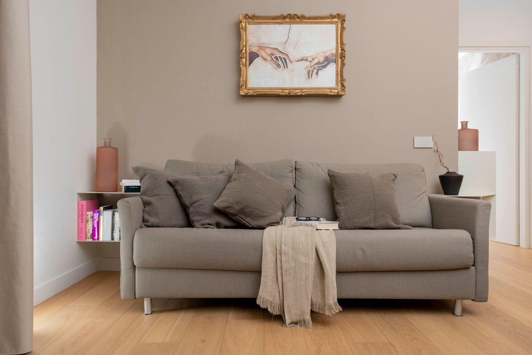 Living room sofa with gilded artwork, Domus Luxury Prati, Rome